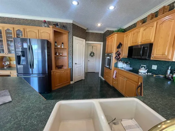 a kitchen with stainless steel appliances granite countertop a sink and cabinets