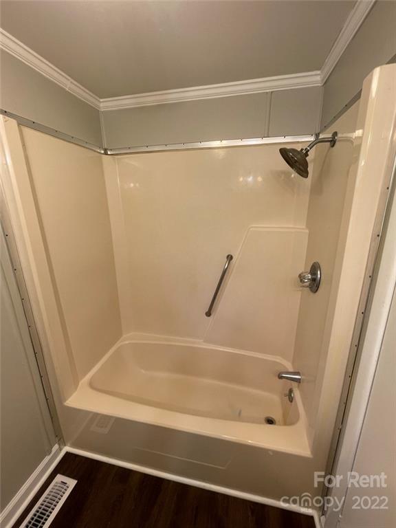 56 Barbee Road Southwest, Unit 1A Concord, NC 28027 - Photo 6 of 9 a bathroom with a shower and a bath tub