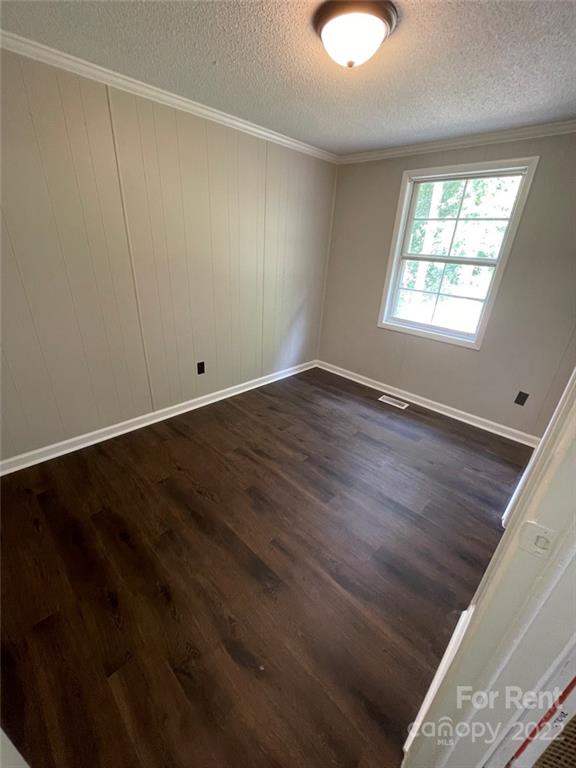 56 Barbee Road Southwest, Unit 1A Concord, NC 28027 - Photo 8 of 9 an empty room with wooden floor and windows