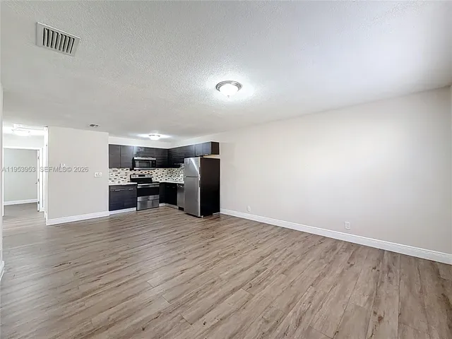 a view of kitchen with wooden floor