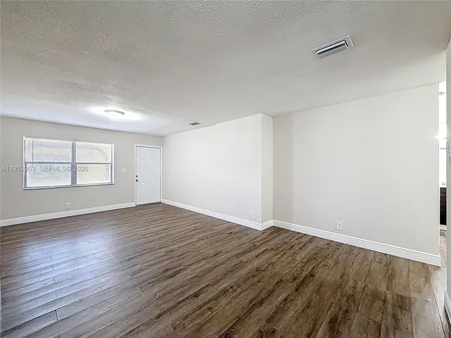 a kitchen with a refrigerator and a stove top oven