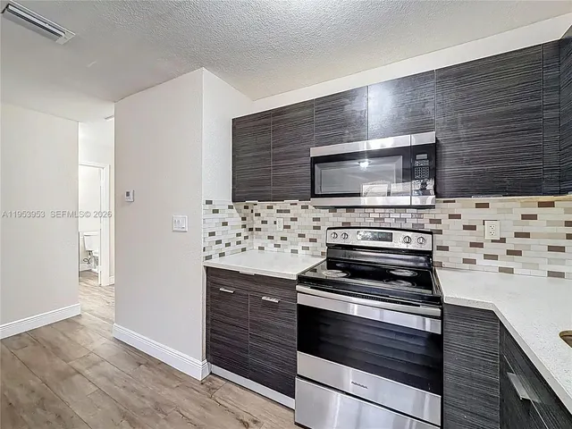 a kitchen with a stove and a refrigerator