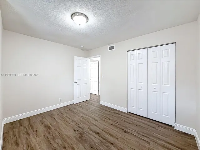 a view of a hallway view with wooden floor and staircase