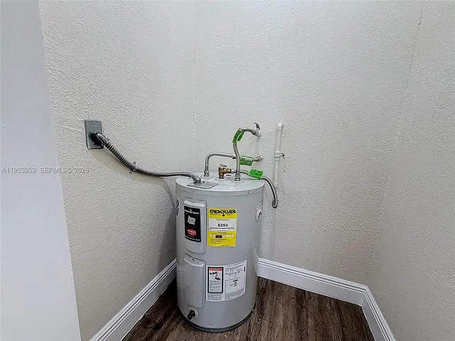 a view of an empty room with closet and a window