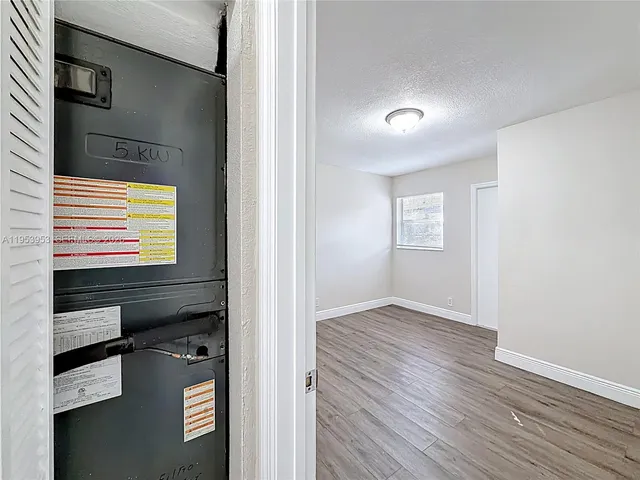 a backyard of a house with barbeque oven table and chairs