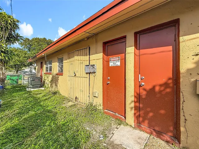 a backyard of a house with table and chairs