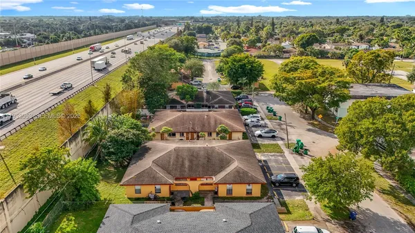 an aerial view of residential houses with outdoor space