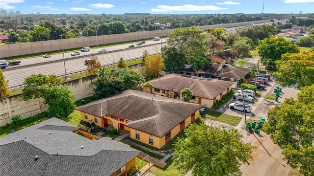 an aerial view of a house with a garden and lake view