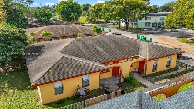 an aerial view of a house with a yard