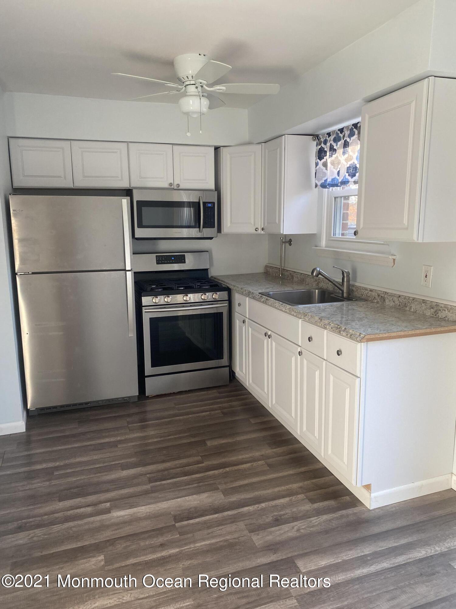 100 Greenwood Loop Road Brick, NJ 08724 - Photo 3 of 6 a kitchen with stainless steel appliances granite countertop a stove a sink and a refrigerator