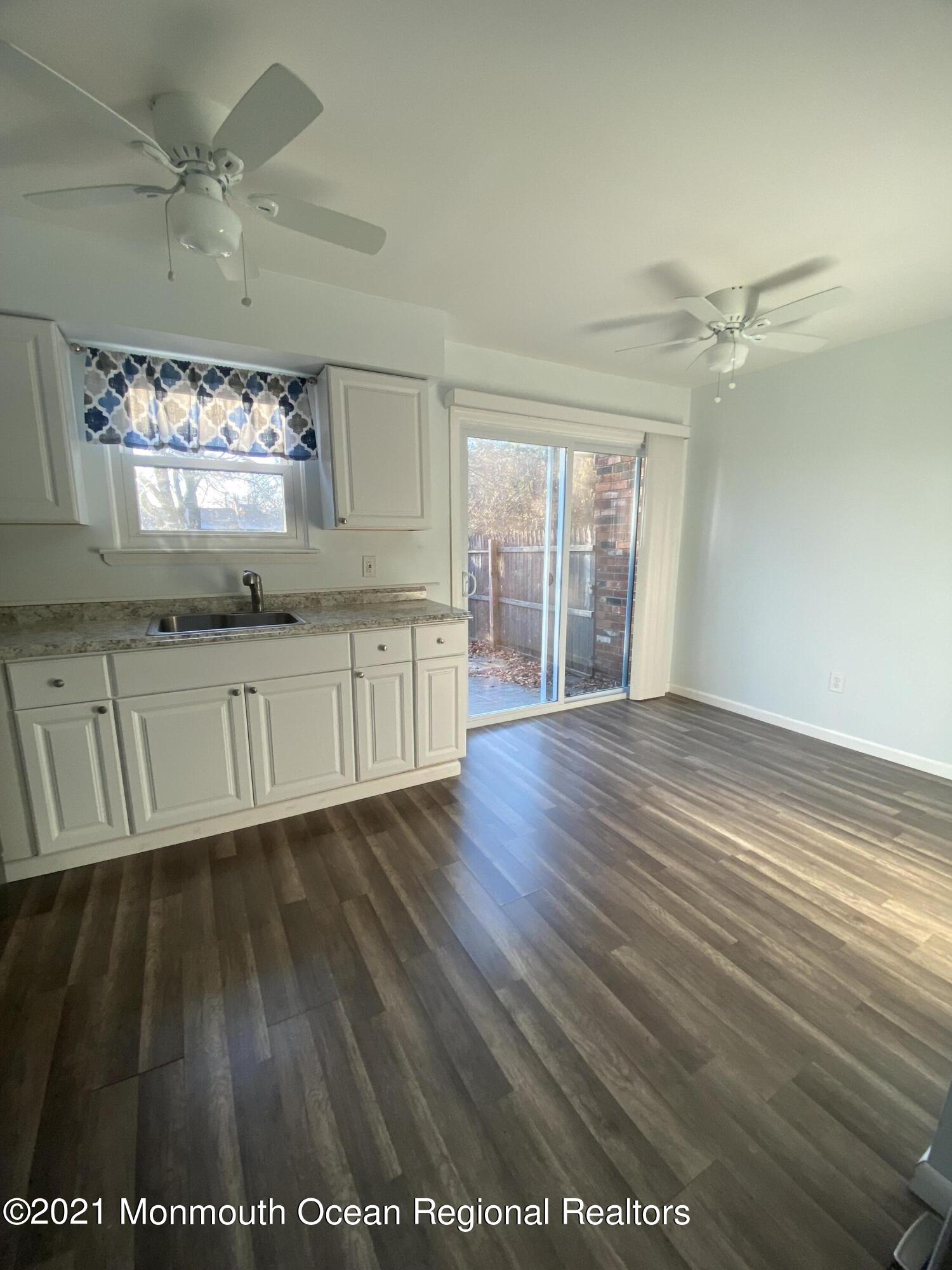 100 Greenwood Loop Road Brick, NJ 08724 - Photo 5 of 6 a view of an empty room with wooden floor and a window