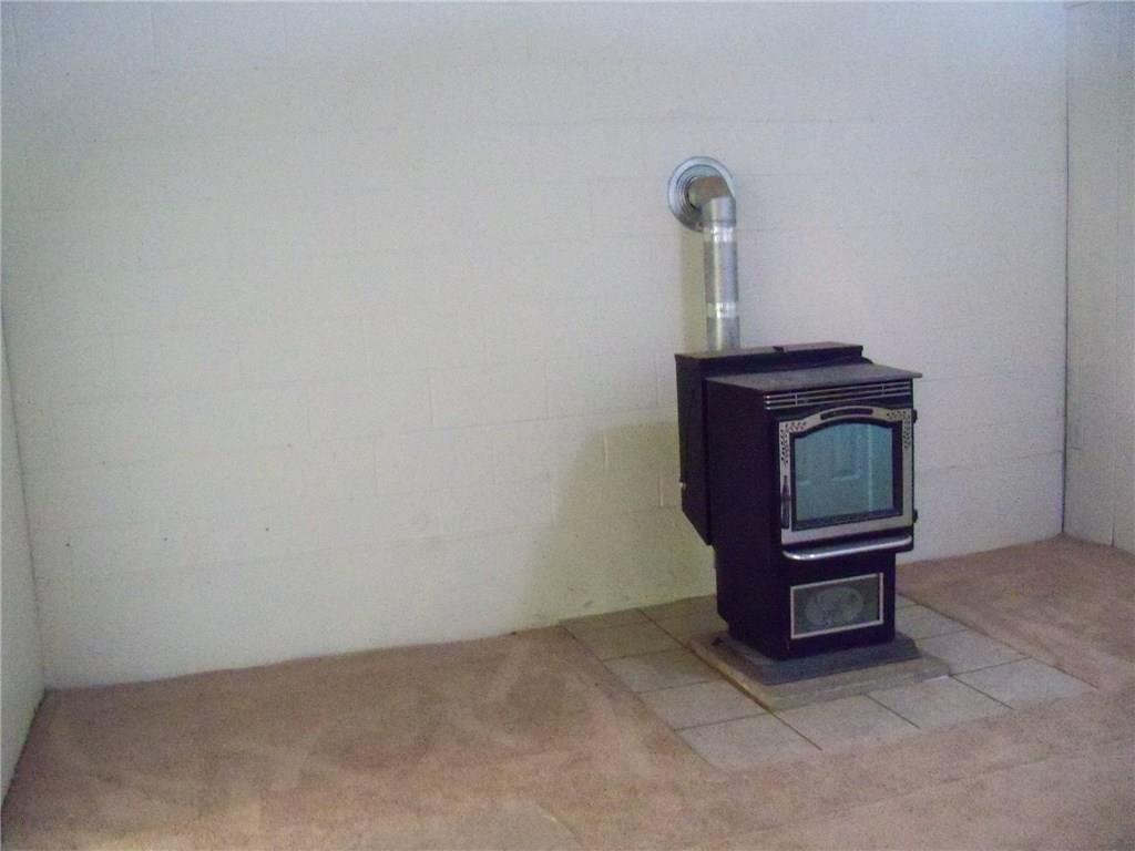 3920 A Ridge Road Aliquippa, PA 15001 - Photo 17 of 25 Extra room in the lower level has new carpet freshly painted, ceramic tile around the Pellet stove that heats the entire home comfortably to save on heating costs