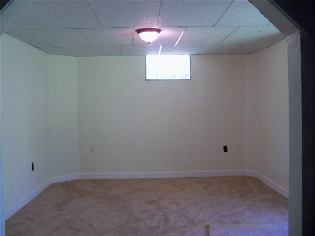 3920 A Ridge Road Aliquippa, PA 15001 - Photo 18 of 25 Game room in lower level freshly painted and new carpet extra high ceilings. Also sliding glass door out to the back
