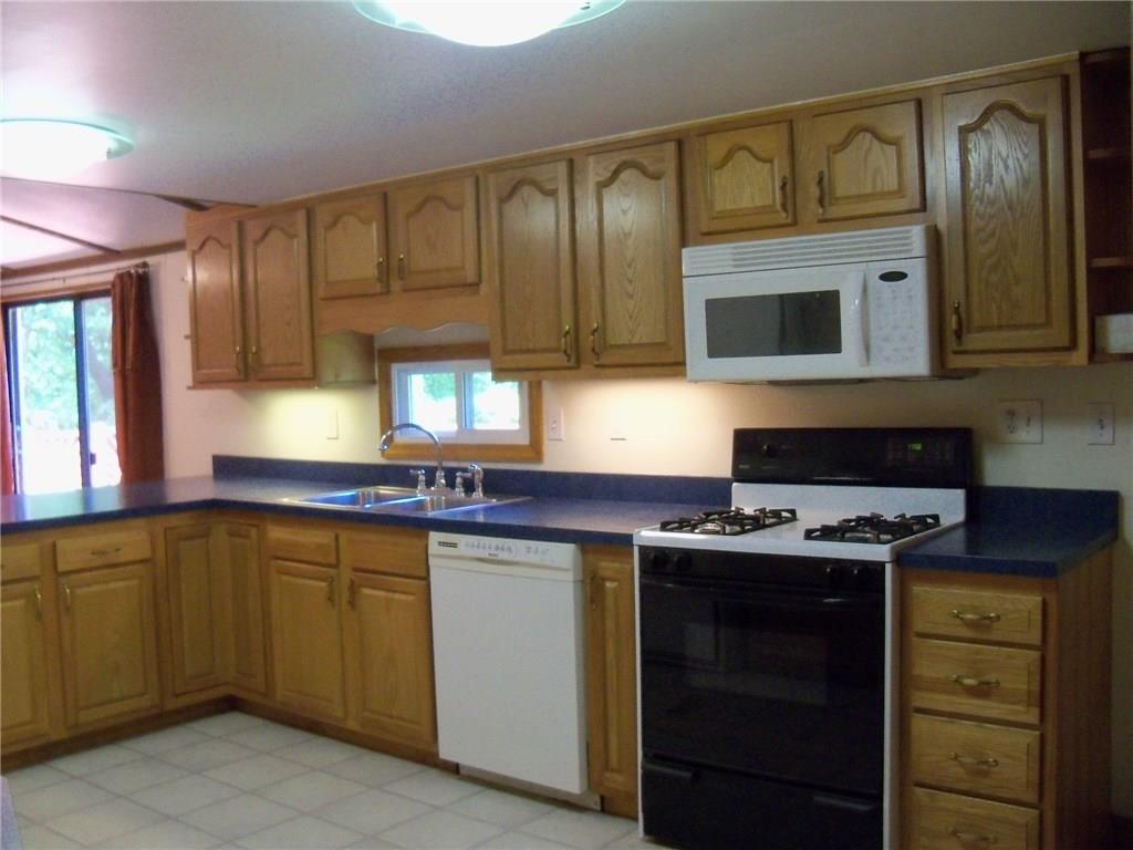 3920 A Ridge Road Aliquippa, PA 15001 - Photo 6 of 25 Updated Kitchen with more than sufficient counter and storage, new window over looking the amazing private back yard and pool
