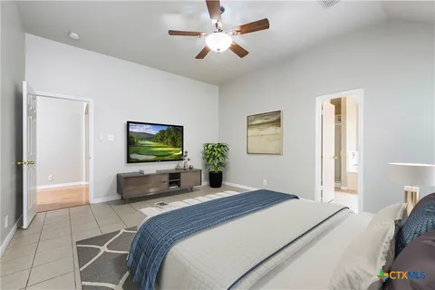 a bedroom with a bed and a flat screen tv