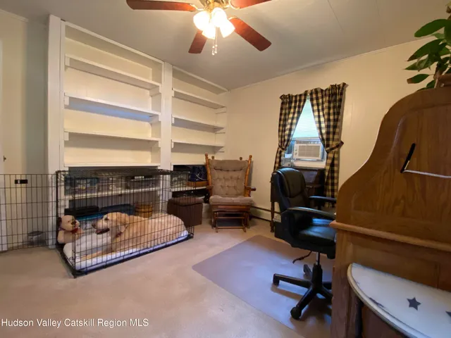 a living room with furniture and a floor to ceiling window