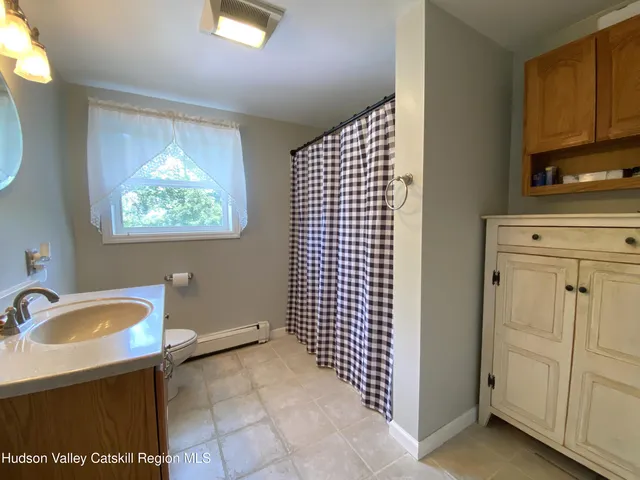 a bedroom with a large bed and a chandelier fan