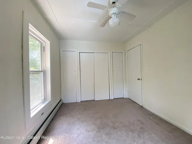 a view of a house with a backyard and furniture