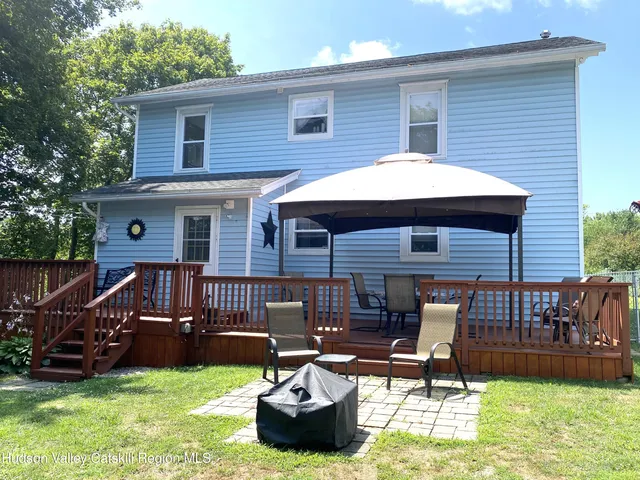 a view of a deck with furniture and a yard