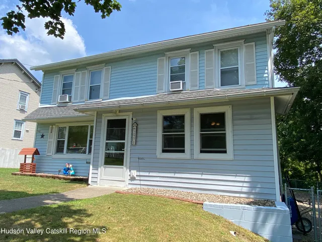 a view of a house with swimming pool and porch