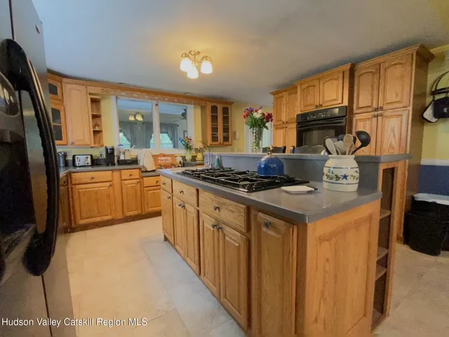 a kitchen with stainless steel appliances granite countertop a stove a sink dishwasher and a refrigerator