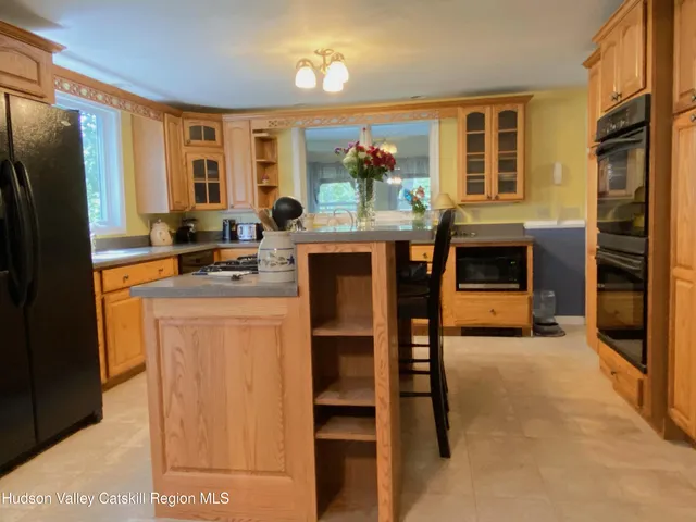 a kitchen with stainless steel appliances granite countertop a refrigerator stove and oven