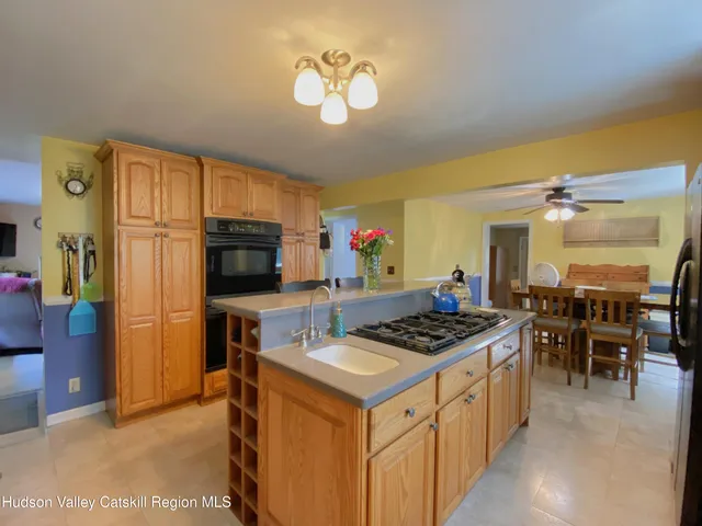 a kitchen that has a lot of cabinets a sink and a stove in it
