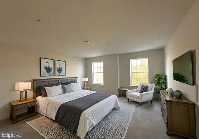 a bedroom with a bed and a flat screen tv