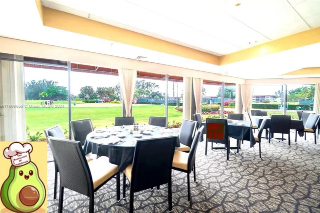 a living room with lots of chairs and a dining table with garden view