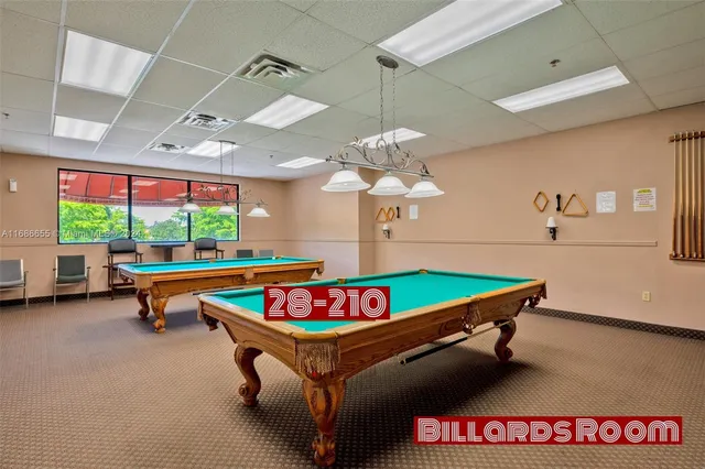 a living room with furniture pool table and a table