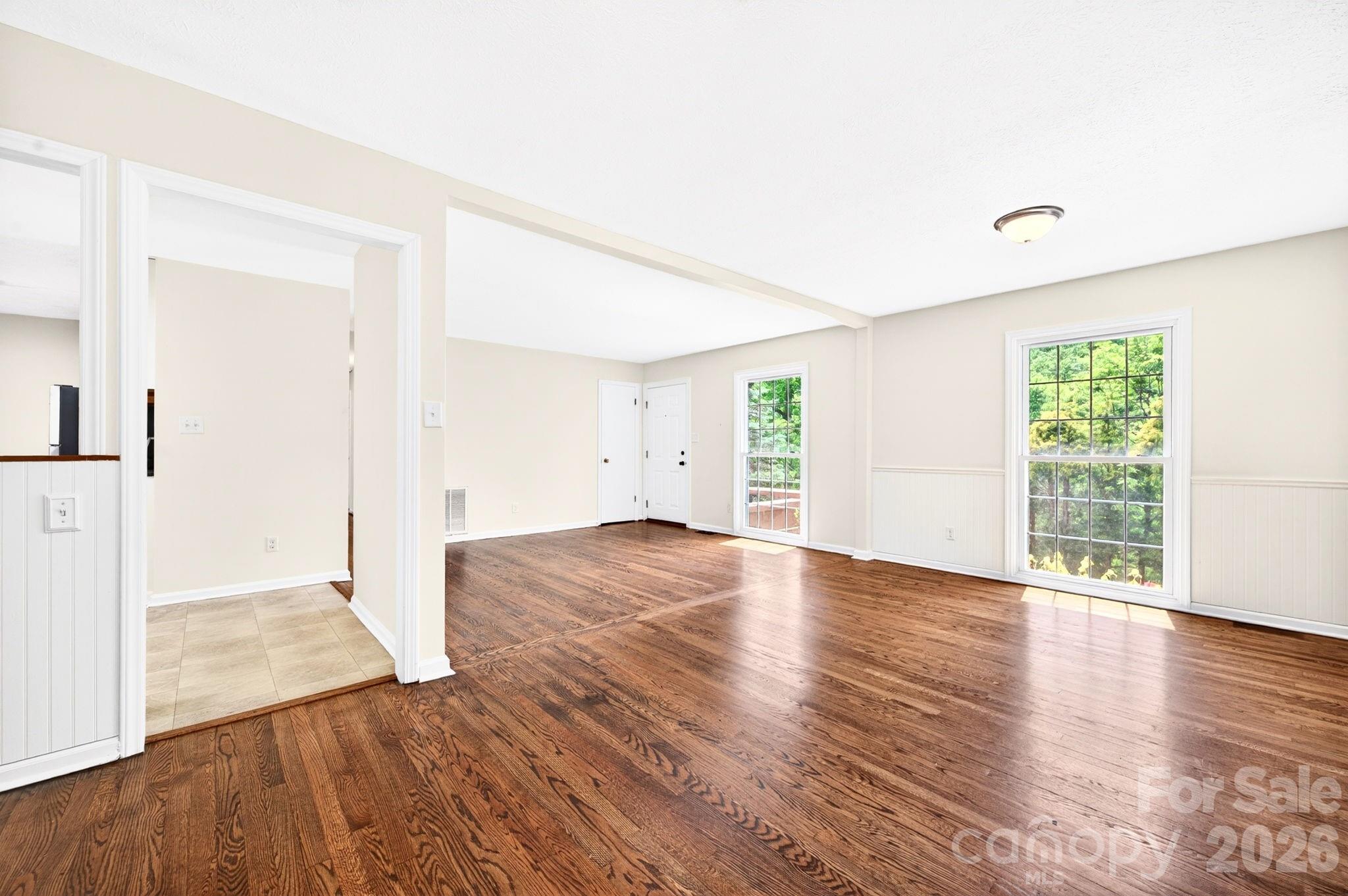34 Wolfe Cove Road Asheville, NC 28804 - Photo 14 of 42 an empty room with wooden floor and windows