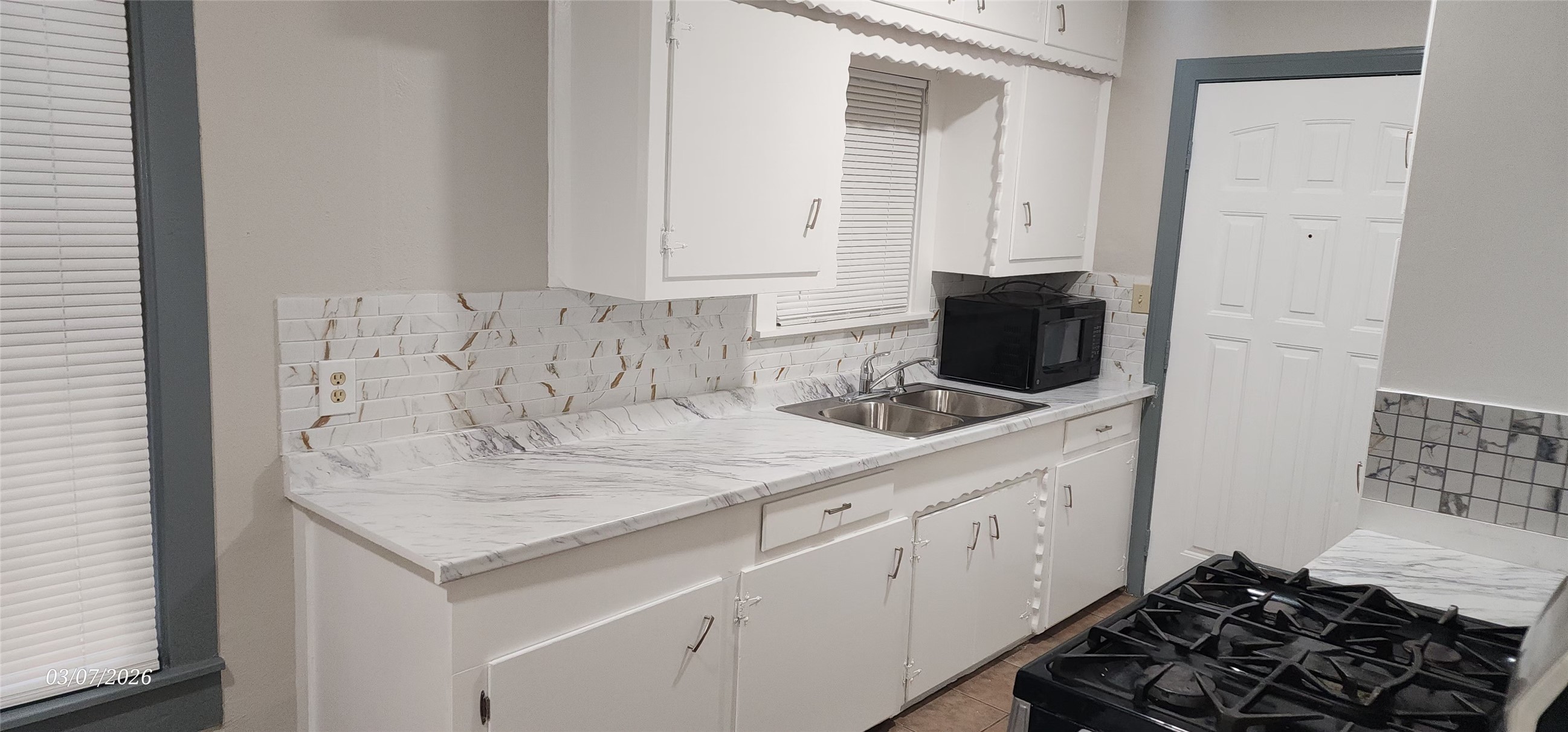 4612 Hain Street Houston, TX 77009 - Photo 4 of 21 a kitchen with a sink stove and cabinets