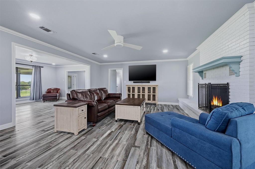 1861-1 Roland Road Whitesboro, TX 76273 - Photo 7 of 39 Living area is spacious - complete with a fireplace and celing fan.