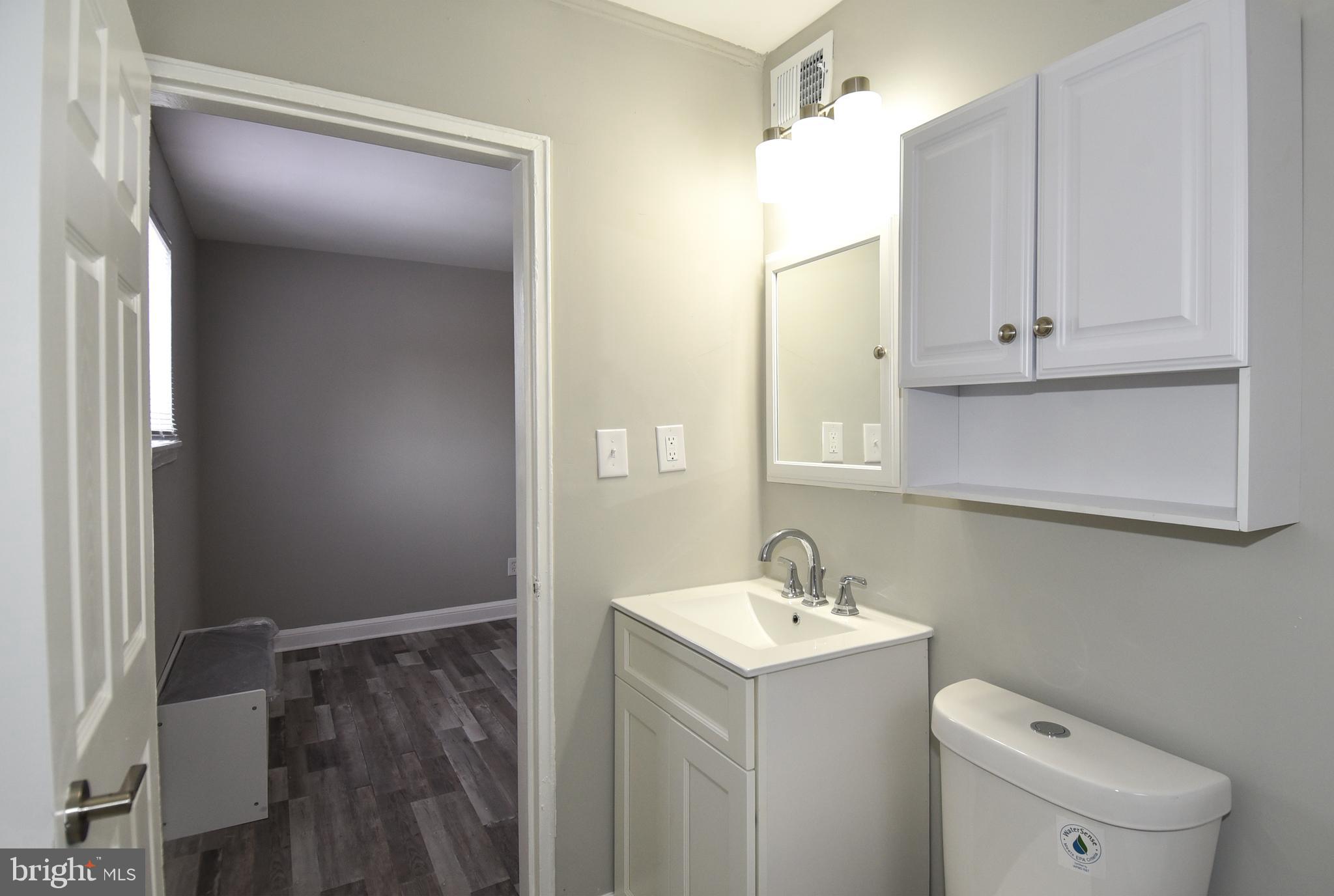 8208 Bellefonte Lane, Unit 3 Clinton, MD 20735 - Photo 12 of 38 a bathroom with a sink a toilet and vanity