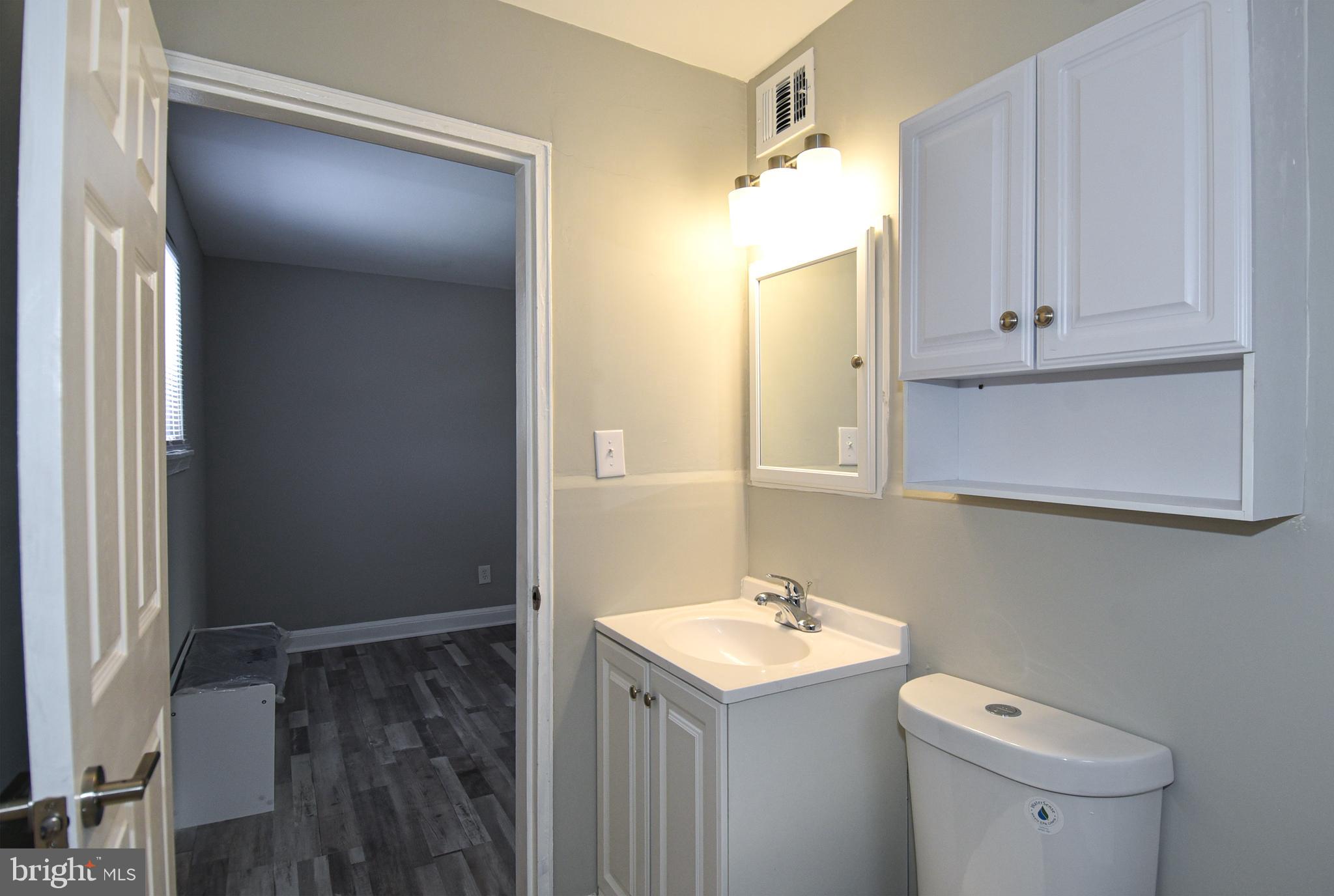 8208 Bellefonte Lane, Unit 3 Clinton, MD 20735 - Photo 16 of 18 a bathroom with a sink a toilet and shower