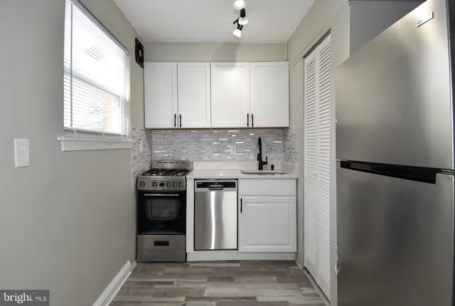 a kitchen with a refrigerator sink and stove