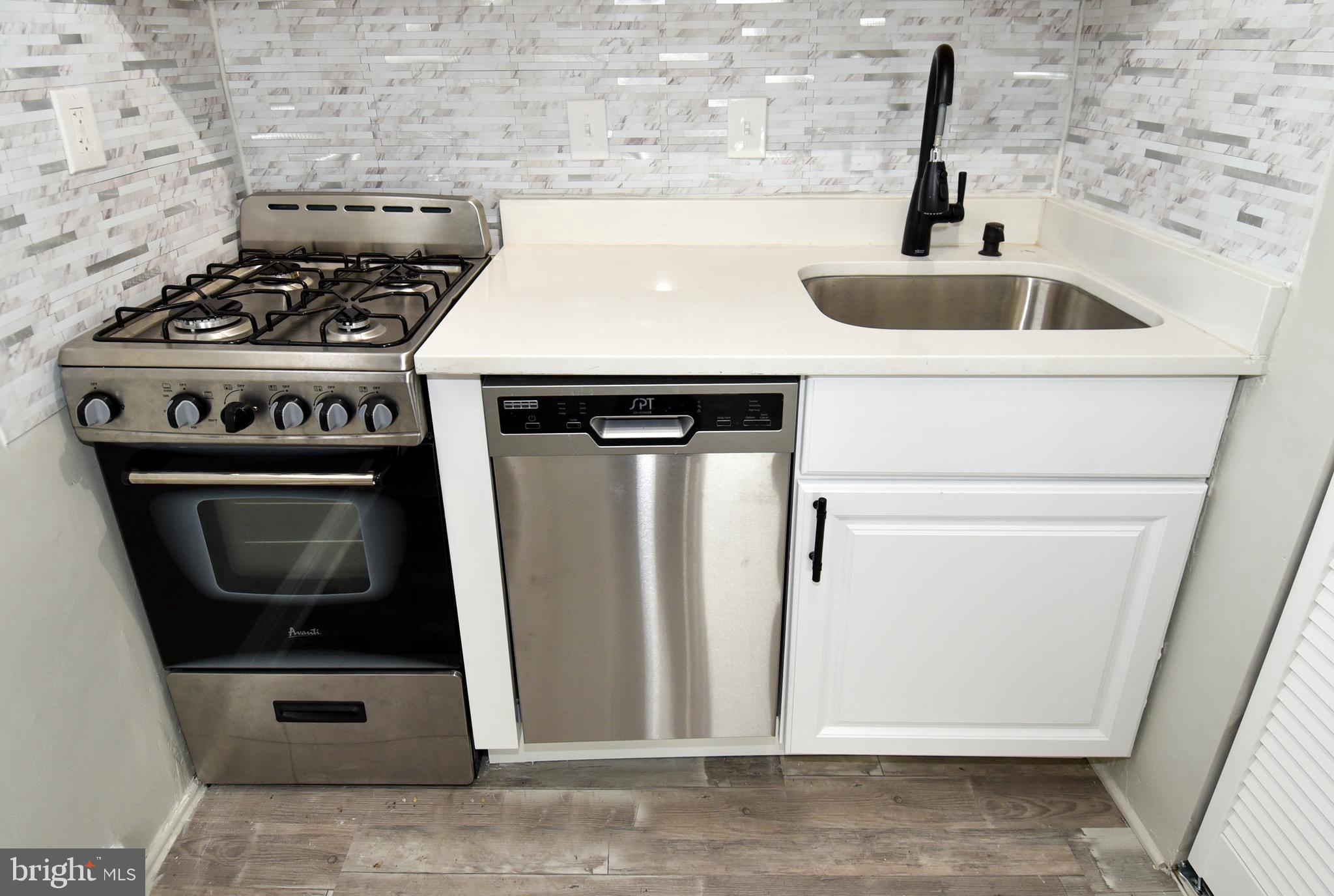 8208 Bellefonte Lane, Unit 3 Clinton, MD 20735 - Photo 20 of 38 a kitchen with a stove and a sink