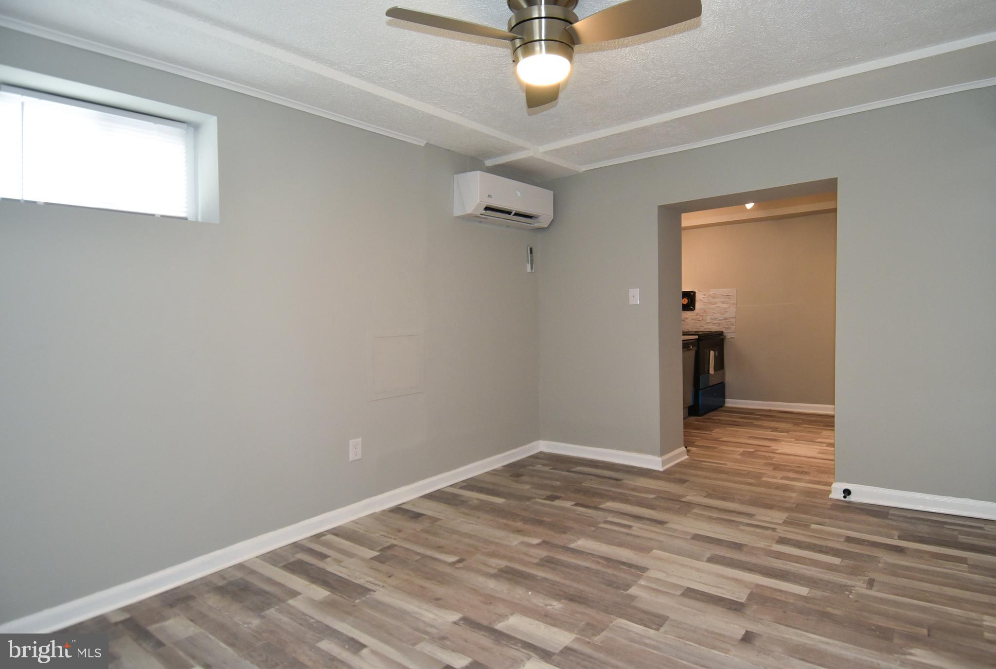 8208 Bellefonte Lane, Unit 3 Clinton, MD 20735 - Photo 27 of 38 a view of a room with a chandelier fan and wooden floor