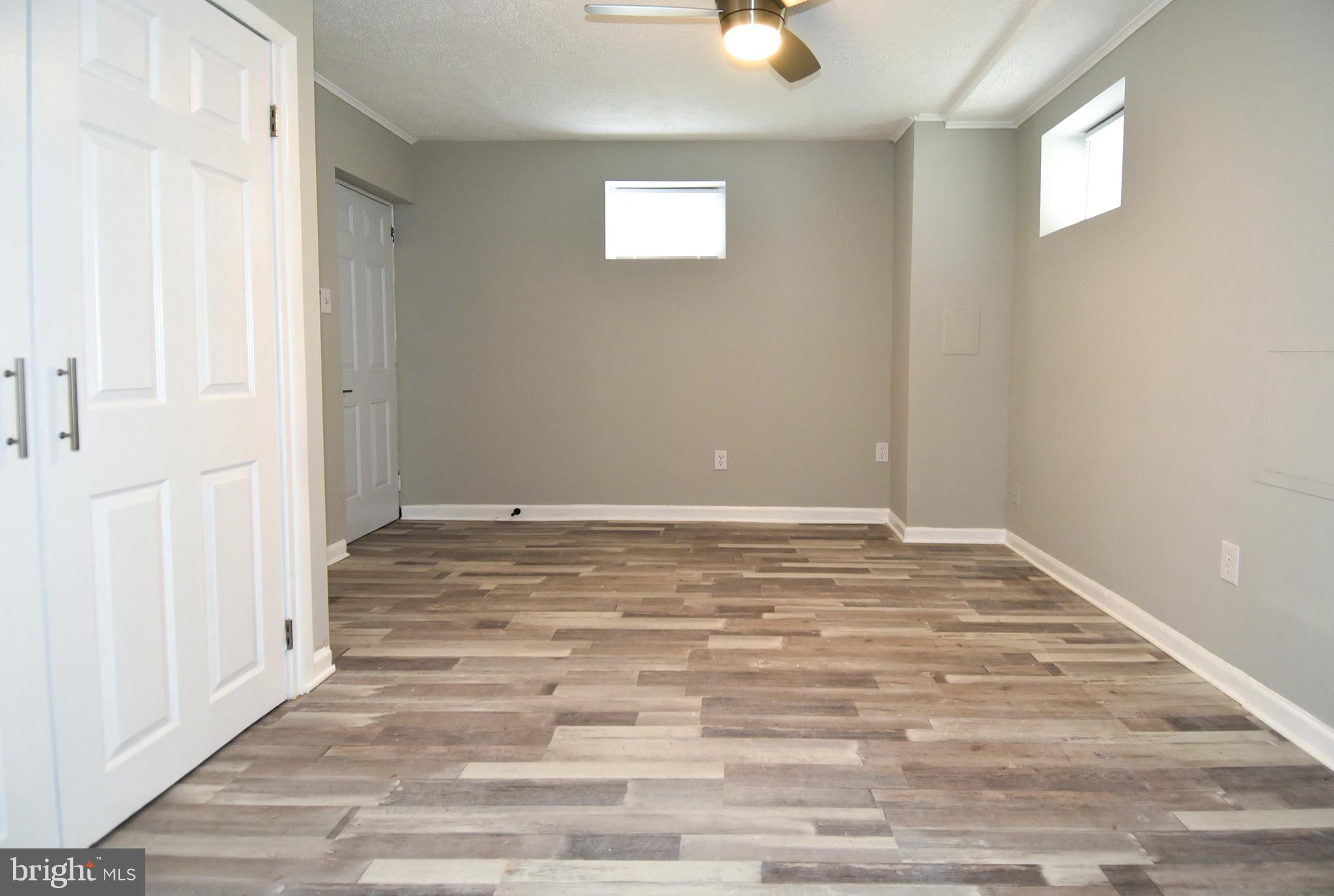 8208 Bellefonte Lane, Unit 3 Clinton, MD 20735 - Photo 31 of 38 a view of a room with wooden floor and white walls