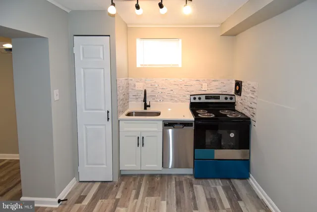 a view of kitchen with refrigerator cabinets and wooden floor