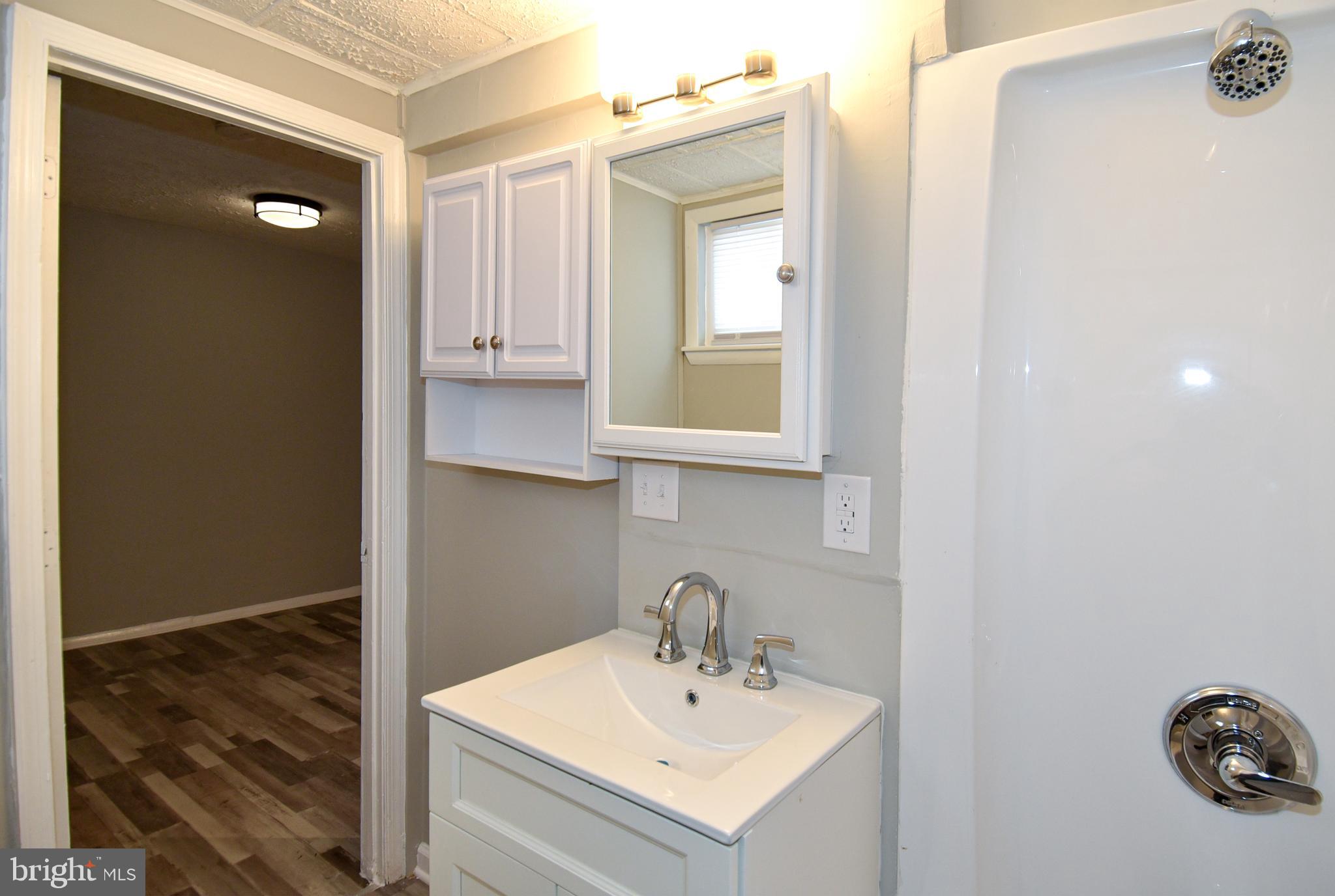 8208 Bellefonte Lane, Unit 3 Clinton, MD 20735 - Photo 37 of 38 a bathroom with a sink and a mirror