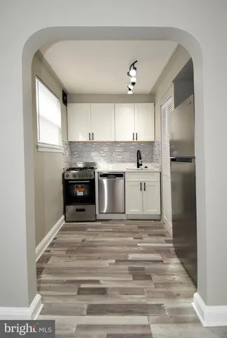 a kitchen with kitchen island a sink stainless steel appliances and cabinets