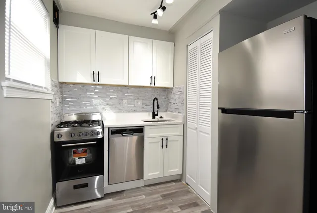 a kitchen with a sink and a stove top oven