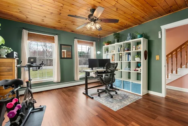 a view of balcony with wooden floor & fence