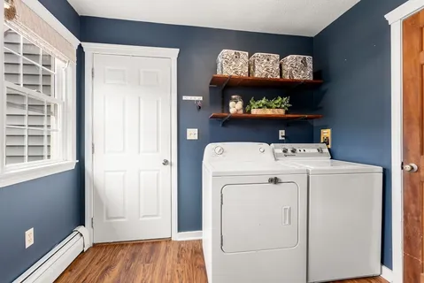 a view of washer and dryer with kitchen in the background