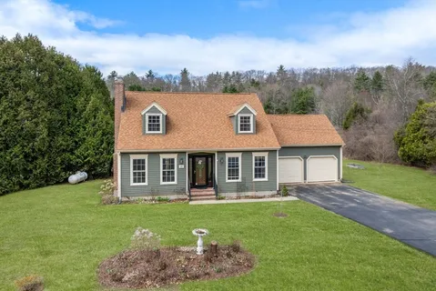 a view of a house with a backyard