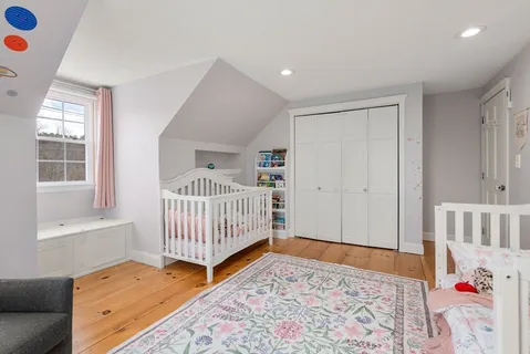 a bedroom with furniture and baby crib