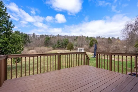 a view of balcony with wooden floor & fence