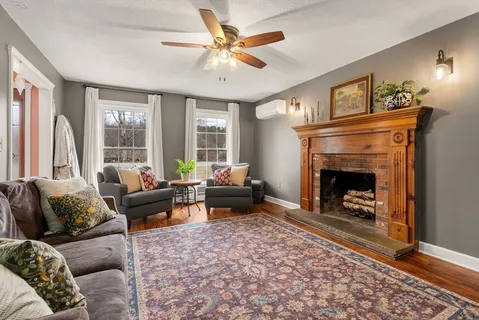 a living room with furniture and a fireplace