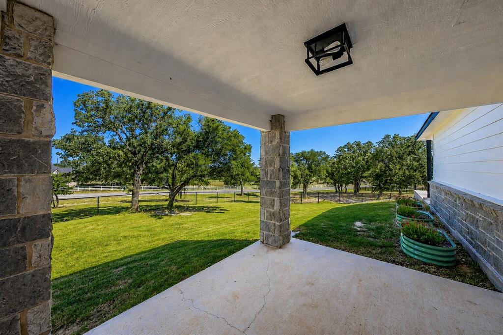 117 Rock Salt Drive Springtown, TX 76082 - Photo 31 of 38 Covered patio with a concrete surface, stone pillar, and recessed ceiling light